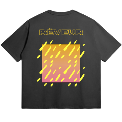 Oversized black streetwear t-shirt “SUNDRIP” by RÊVEUR — modern abstract design with yellow and pink gradient square and dripping shapes, minimalist and artistic style.