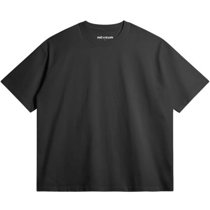 Oversized black streetwear t-shirt by RÊVEUR — minimalist front design, premium 305g cotton, high-quality oversized fit.
