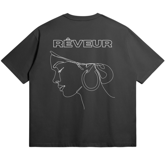 Oversized black streetwear t-shirt “SERENA” by RÊVEUR — minimalist line art design of a woman’s profile with hoop earrings, elegant and artistic style.