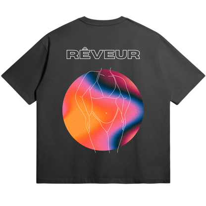 Oversized black streetwear t-shirt “SHE” by RÊVEUR — artistic minimalist line art of a woman’s body with a colorful gradient circle, celebrating creative freedom and body positivity.