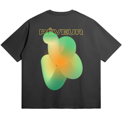 Oversized black streetwear t-shirt “SOLAR KNOT” by RÊVEUR — minimalist artistic design with green and orange abstract gradient pattern on the back.