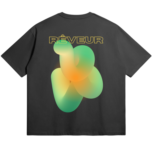Oversized black streetwear t-shirt “SOLAR KNOT” by RÊVEUR — minimalist artistic design with green and orange abstract gradient pattern on the back.