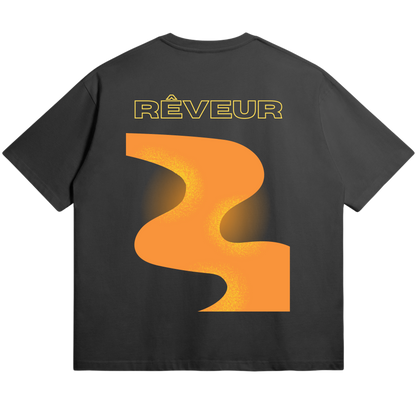 Oversized black streetwear t-shirt “THE WAY” by RÊVEUR — minimalist artistic design with bold orange abstract print on the back.