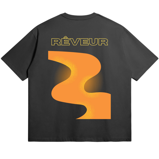 Oversized black streetwear t-shirt “THE WAY” by RÊVEUR — minimalist artistic design with bold orange abstract print on the back.